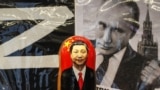 RUSSIA – A Russian matryoshka doll with a portrait of the Chinese President Xi Jinping displayed in front of a photograph of Russian President Vladimir Putin in a street souvenir shop in downtown Moscow, Russia, 20 March 2023 