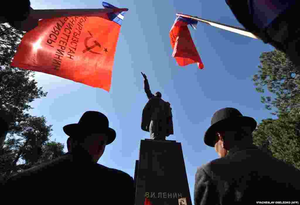 Kyrgyz Communist Party supporters hold red flags in front of a monument to Vladimir Lenin during a rally to mark the May Day holiday in Bishkek.&nbsp;