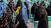 Afghan women gather around aid parcels that they received from the King Salman Humanitarian Aid and Relief Center in Herat in June.