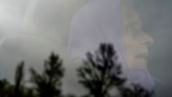 A woman looks though the window of a car during evacuation after her house was heavily damaged by a Russian air strike in the Kharkiv region on April 16.