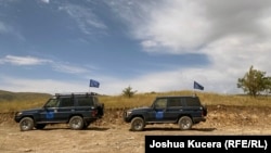 EUMA monitors' vehicles parked as they observe the new Azerbaijani line of contact above the Armenian resort town of Jermuk.