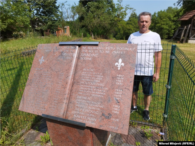 Fikret Bačić pored spomenika svojoj djeci i drugim članovima porodice ubijenim 25. jula 1992. godine, selo Zecovi, Prijedor, 11. jul 2023. godine