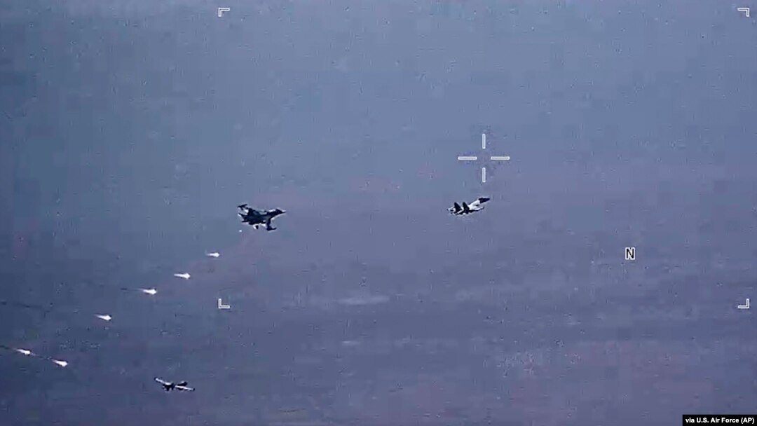 In this image from video released by the U.S. Air Force, Russian military jets release flares in the flight path of a U.S. Air Force MQ-9 Reaper drone on July 6. The United States said on July 8 that its drones had been harassed for the third day in a row.