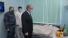 Kazakh President Qasym-Zhomart Toqaev visits a patient in Almaty in January 2022 who was injured during the bloody protests earlier that month. 