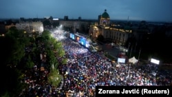 Supporters of Serbian President Aleksandar Vucic take part in a rally in support of his policies and the ruling Serbian Progressive Party in Belgrade on May 26.