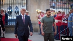 Czech President Petr Pavel walks with Ukrainian President Volodymyr Zelenskiy outside Prague Castle on July 6.