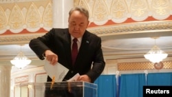 Former Kazakh President Nursultan Nazarbaev votes during the parliamentary election in Astana on March 19.