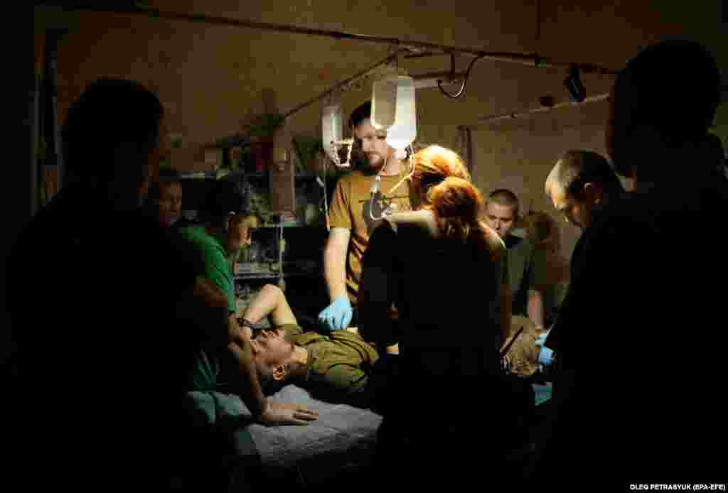 Ukrainian combat medics of the 5th Assault Brigade treat wounded servicemen near Bakhmut in the Donetsk region.