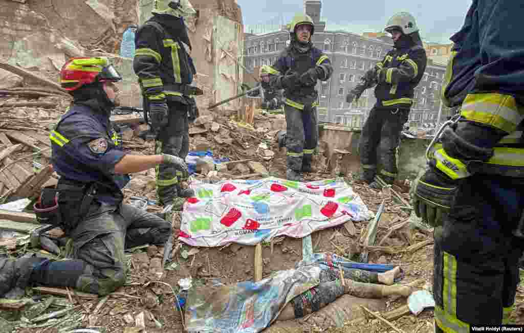 Emergency workers remove the body of a 10-year-old boy. Tymofii, who was killed in the strike that hit a multistory building in central Kharkiv, Mayor Ihor Terekhov and regional Governor Oleh Synyehubov&nbsp;said&nbsp;on October 6. &quot;The child was found under the rubble of a residential building. Unfortunately dead. Condolences to the parents and relatives,&quot; Terekhov wrote on Telegram.