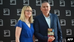 Bulgarian author Georgi Gospodinov (right) and U.S. literary translator Angela Rodel pose with the book Time Shelter on the red carpet upon arrival for the International Booker Prize award ceremony in central London on May 23.