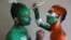 Cricket fans paint their bodies in the Indian and Pakistani national flag colors ahead of the match between India and Pakistan in the Cricket World Cup, in Ahmedabad, India.