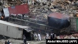 PHOTO GALLERY: Massive Landslide Buries Trucks In Pakistan