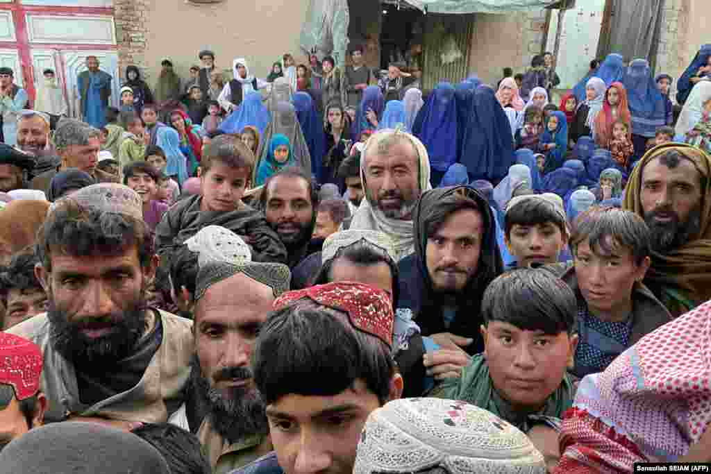 Afghans wait to receive free food from a local charity during the Islamic holy fasting month of Ramadan in Kandahar on April 2.