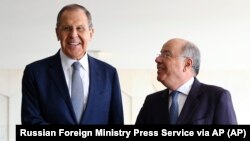 Russian Foreign Minister Sergei Lavrov (left) shakes hands with Brazilian Foreign Minister Mauro Vieira prior to their talks in Brasilia on April 17.