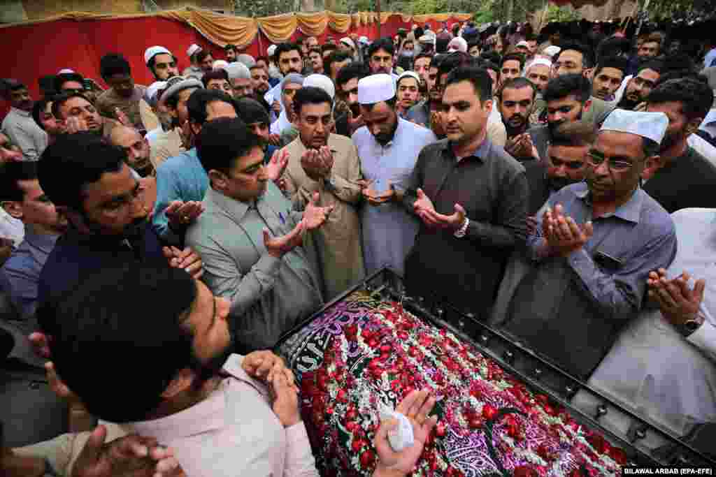 Relatives and other guests attend the funeral of Pakistani teenager Azan Afridi, one of the victims of a boat wreck off the coast of Italy, in Peshawar.