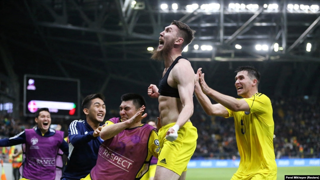 Kazakhstan's Abat Aimbetov (center) celebrates scoring the winning goal with teammates on March 26.