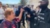 A Kazakh woman expresses anger outside the courthouse at a July 11, 2023, sentencing in the case of the Almaty airport seizure during the Bloody January events.