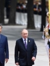 Chinese President Xi Jinpin (left) and Russian President Vladimir Putin as they review an honor guard during a visit to Beijing by the Russian leader last year. (file photo) 