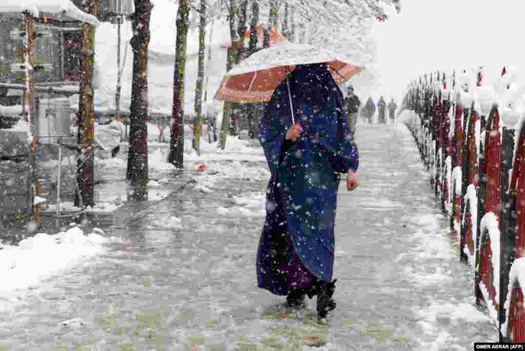 An Afghan woman during a snowfall in Fayzabad, Badakhshan Province
