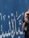 An Iranian woman drinks water during hot weather in Tehran, Iran, 22 July 2024.