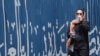 An Iranian woman drinks water during hot weather in Tehran, Iran, 22 July 2024.