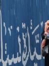 An Iranian woman drinks water during hot weather in Tehran, Iran, 22 July 2024.