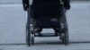 Woman in wheelchair, person with disabilities, moving through streets, Sarajevo, June 2023.