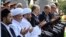 Mufti Nuriddin Kholiqnazarov (from 3rd left to right), President Shavkat Mirziyoev, and Prime Minister Abdulla Aripov pray during a public appearance in Tashkent on August 31.