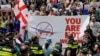 People protest the resumption of air links with Russia during the arrival of the first direct flight from Moscow to Tbilisi on May 19.