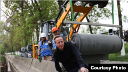 Cameron visits an irrigation project in Kyrgyzstan.