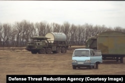 Military and civilian vehicles seen during a 1995 visit to an intercontinental ballistic missile base as part of the silo dismantlement project.