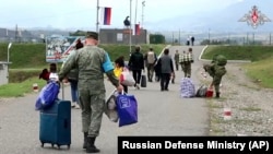 Nagorno-Karabakh - Russian peacekeepers help ethnic Armenian civilians to take shelter at their base near Stepanakert, September 21, 2023