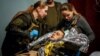 Military medics evacuate a wounded Ukrainian soldier from a frontline medical stabilization point near Bakhmut on May 5.