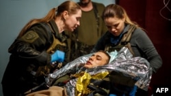 Military medics evacuate a wounded Ukrainian soldier from a frontline medical stabilization point near Bakhmut on May 5.