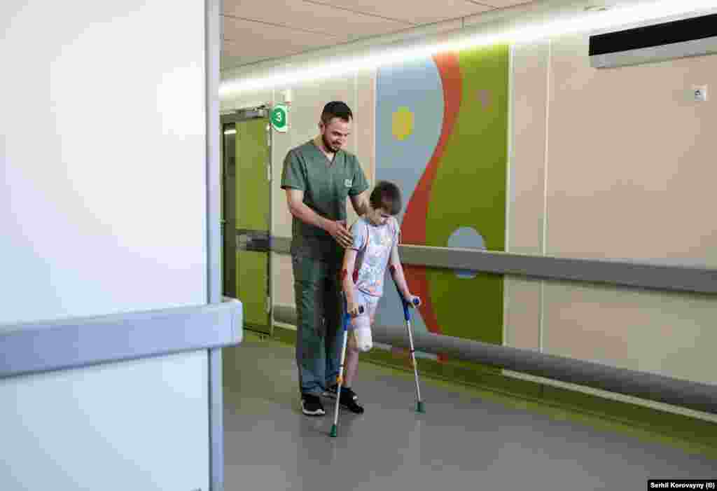 Sashko, an 11-year-old survivor of a shelling attack, being helped to use crutches by a staff member of the Okhmatdyt hospital in March 2024. In January 2024, Sashko was walking to his local shop in the Kharkiv region with his cousin Alina when a shell exploded nearby. The blast tore off the boy&rsquo;s leg and fatally wounded Alina, who died after 10 days in intensive care. &nbsp;