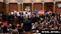 Members of the Serbia Against Violence coalition blew whistles and waved banners reading "Election fraud" and "You stole the elections" in the Serbian National Assembly on February 6. 