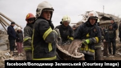 Rescue workers look for survivors amid the rubble of a residential building that was hit by a Russian missile strike in Ukraine's Lviv region on March 9.