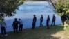 Serbian Police officers search the bank of the Drina River after a boat carrying imigrants sank on the border between Serbia and Bosnia-Herzegovina near the town of Ljubovija on August 22.