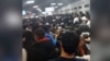 Russia - migrants waiting in long lines at migration center amid backlash against workers from Central Asia - screen grab