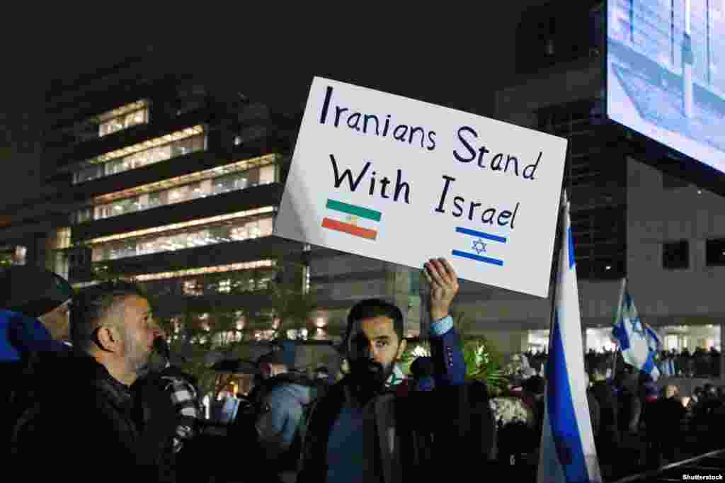 A man holds a sign during a rally in support of Israel in Toronto, Canada, on October 9.&nbsp;