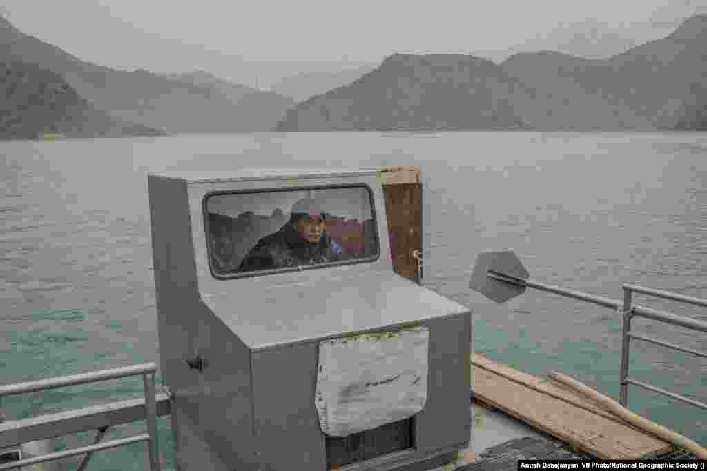 Sonunbek Kadyrov pilots his water taxi, serving the village of Kyzyl-Beyit, Kyrgyzstan, on March 16, 2021. Local access to the main road was blocked by flooding during construction of the Toktogul Dam in the 1960s. World Press Photo Long-Term Project Award: Battered Waters by&nbsp;Anush Babajanyan, VII Photo/National Geographic Society &nbsp;