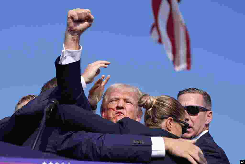 As he was being led off of the stage, Trump turned toward the crowd, pumped his fist in the air and appeared to yell, &quot;Fight, fight, fight!&quot;