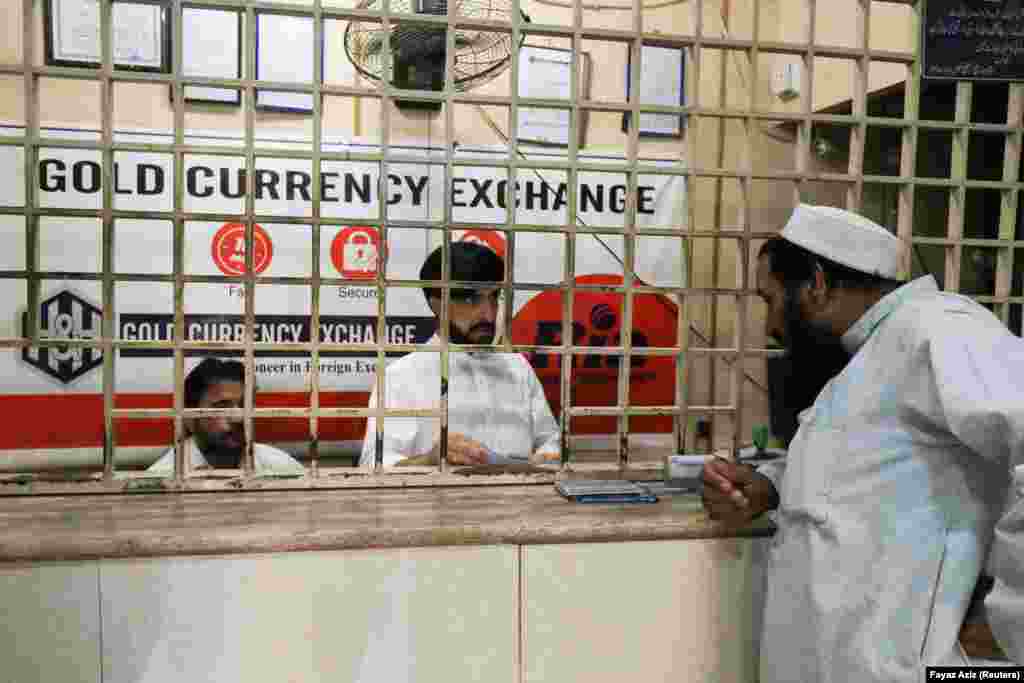 A man speaks with a currency dealer at a foreign exchange shop in Peshawar. More than 45 shops were closed in Peshawar&rsquo;s Chowk Yadgar area --&nbsp; the province&rsquo;s largest currency market -- following the government crackdown. &nbsp; With their closure, Islamabad aims to quash money laundering, terrorist financing, and tax evasion while also ensuring government oversight and control over financial transactions, thereby safeguarding the stability and integrity of its financial systems.
