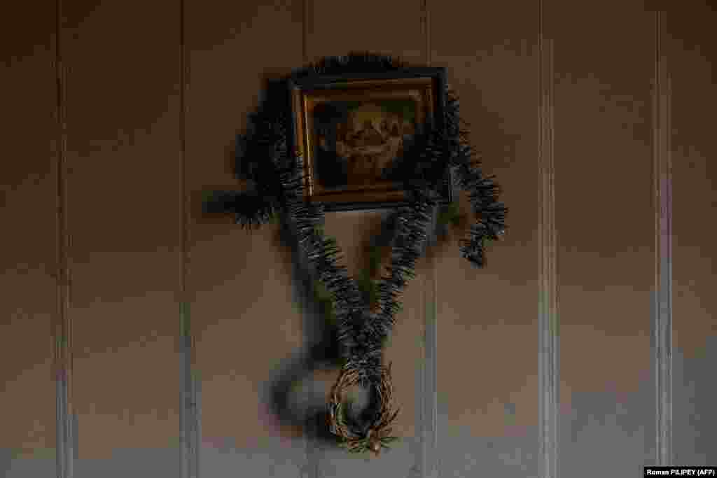 A religious icon, discolored from smoke following a Russian missile attack, hangs on a wall in a residential home.