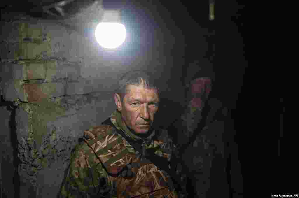 Ukrainian soldiers wait it out in a shelter in Bakhmut. Kyiv says ammunition and weapons shortfalls are hindering its ability to launch a counteroffensive.