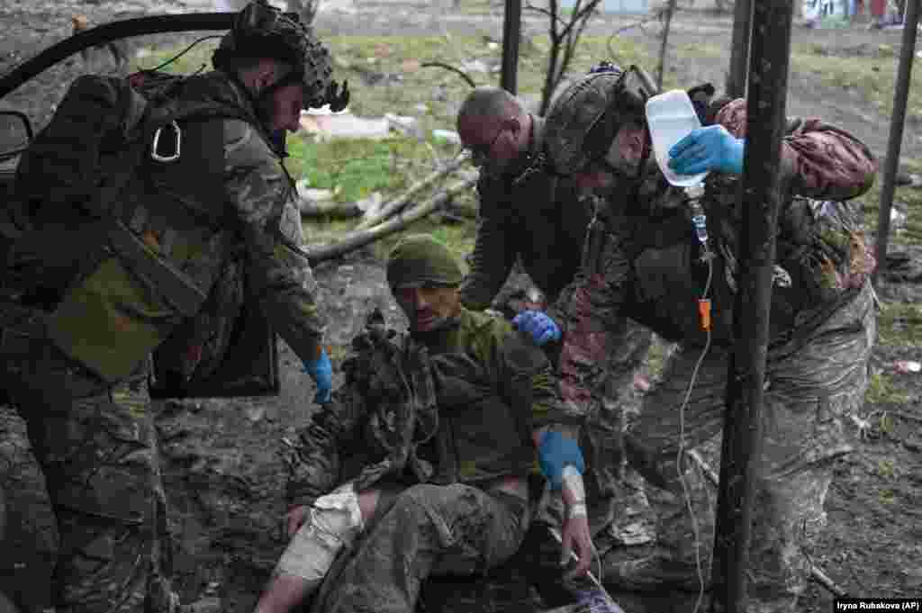 Ukrainian soldiers in Bakhmut give first aid to a wounded colleague. Kyiv asserts that its defense of Bakhmut is necessary to inflict huge losses on the Russian invaders, but it admits that its own forces have paid a heavy price in manpower.
