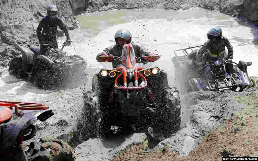 ATV drivers try to cross a mud pit during a spring festival in the village of Ozernoye, about 35 kilometers from Bishkek, on April 14.