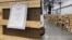 A screen grab from a viral video that purportedly shows makeshift wooden coffins with death certificates tacked onto each one at Tolmachevo Airport in the Siberian city of Novosibirsk. 