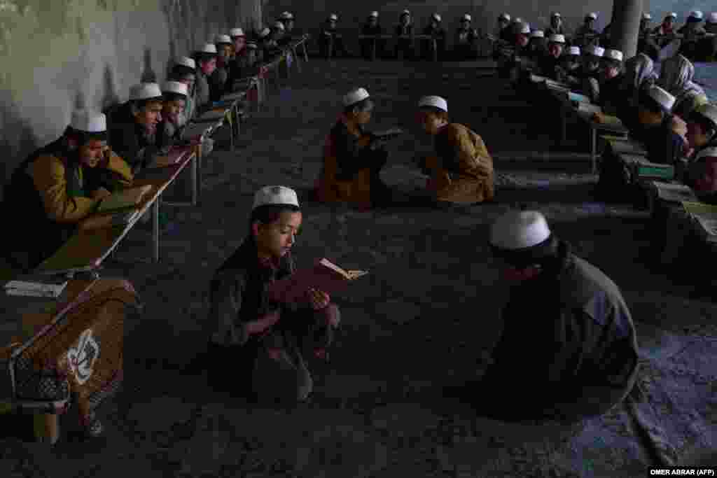 Afghan children read the Koran at a madrasah, or Islamic school, during the holy month of Ramadan in Badakhshan Province.