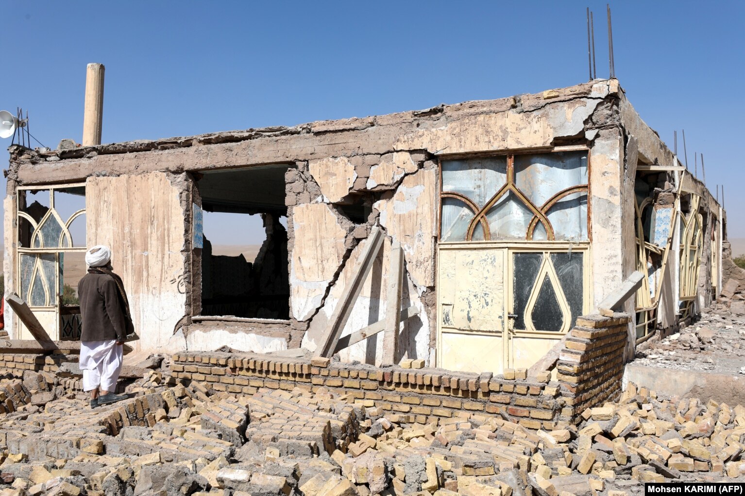 A man surveys quake damage to a house. The epicenter of the first earthquake was some 40 kilometers northwest of Herat, which has some 700,000 people in the city and the surrounding area. It was followed by at least three major aftershocks.